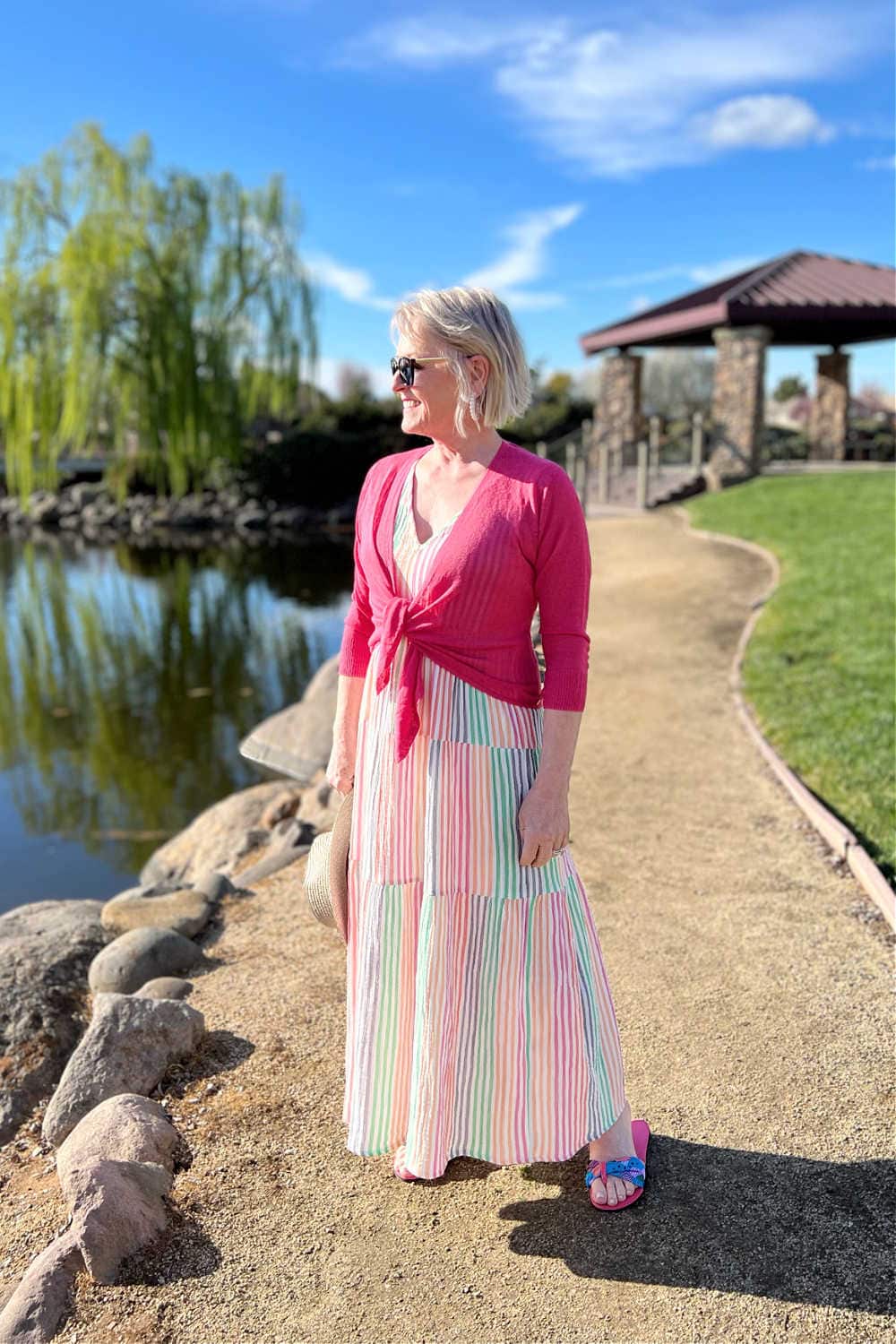 woman wearing 4 way cardigan over striped dress