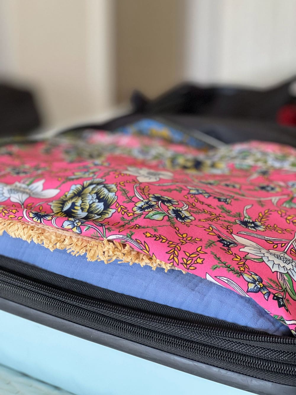 hat covered with clothes in suitcase