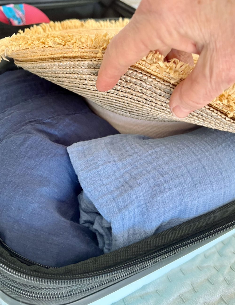 layering SOFT CLOTHES UNDER BRIM of hat in carryon suitcase