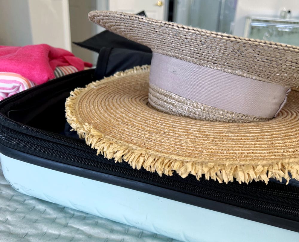 HATS STACKED IN CARRY-ON BAG