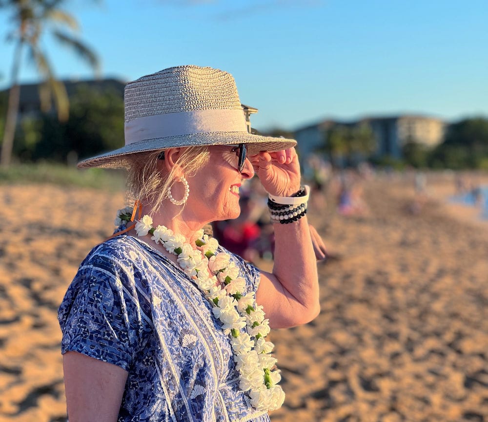 woman on beach wearing kaftan and brixton joanna straw hat