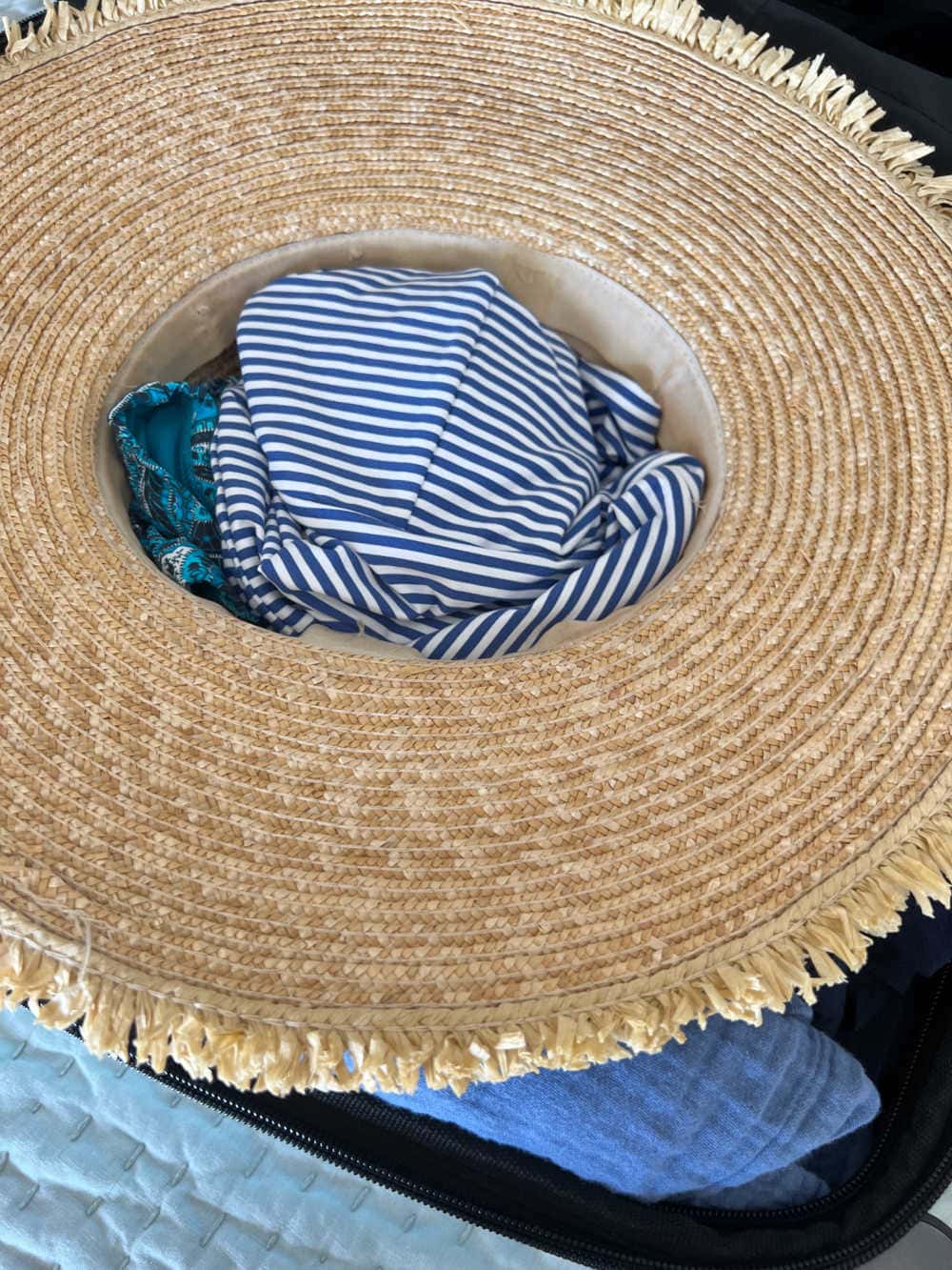 Prevent your hat from getting crushed in a suitcase—fill the crown with soft travel essentials for support.