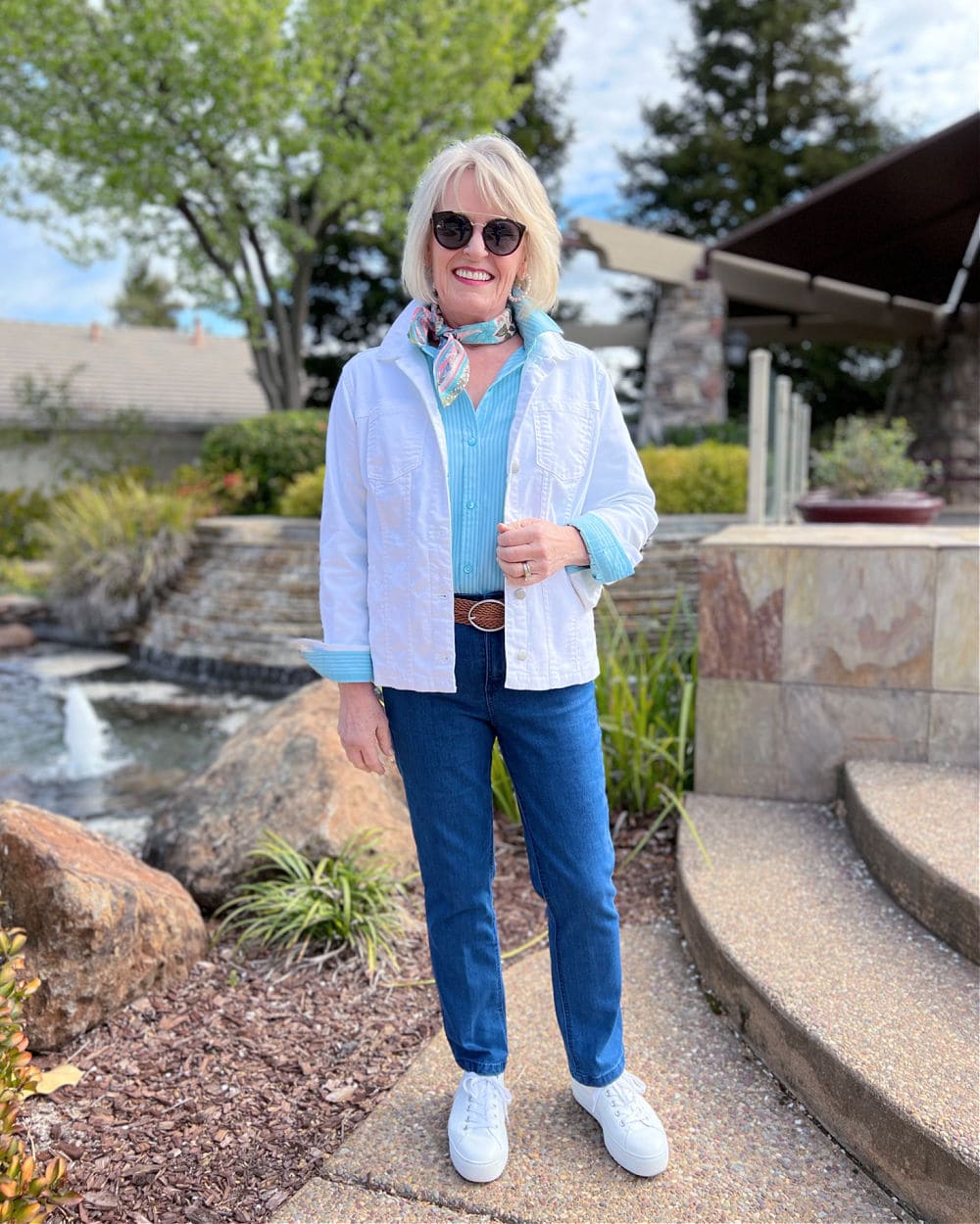 woman wearing white jacket and jeans