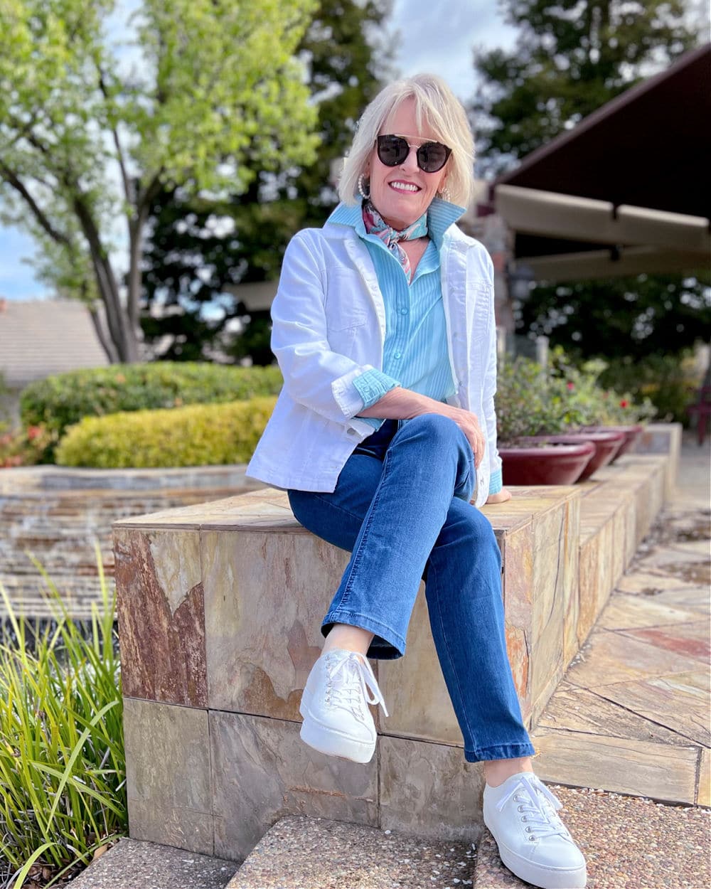woman sitting on stone wall