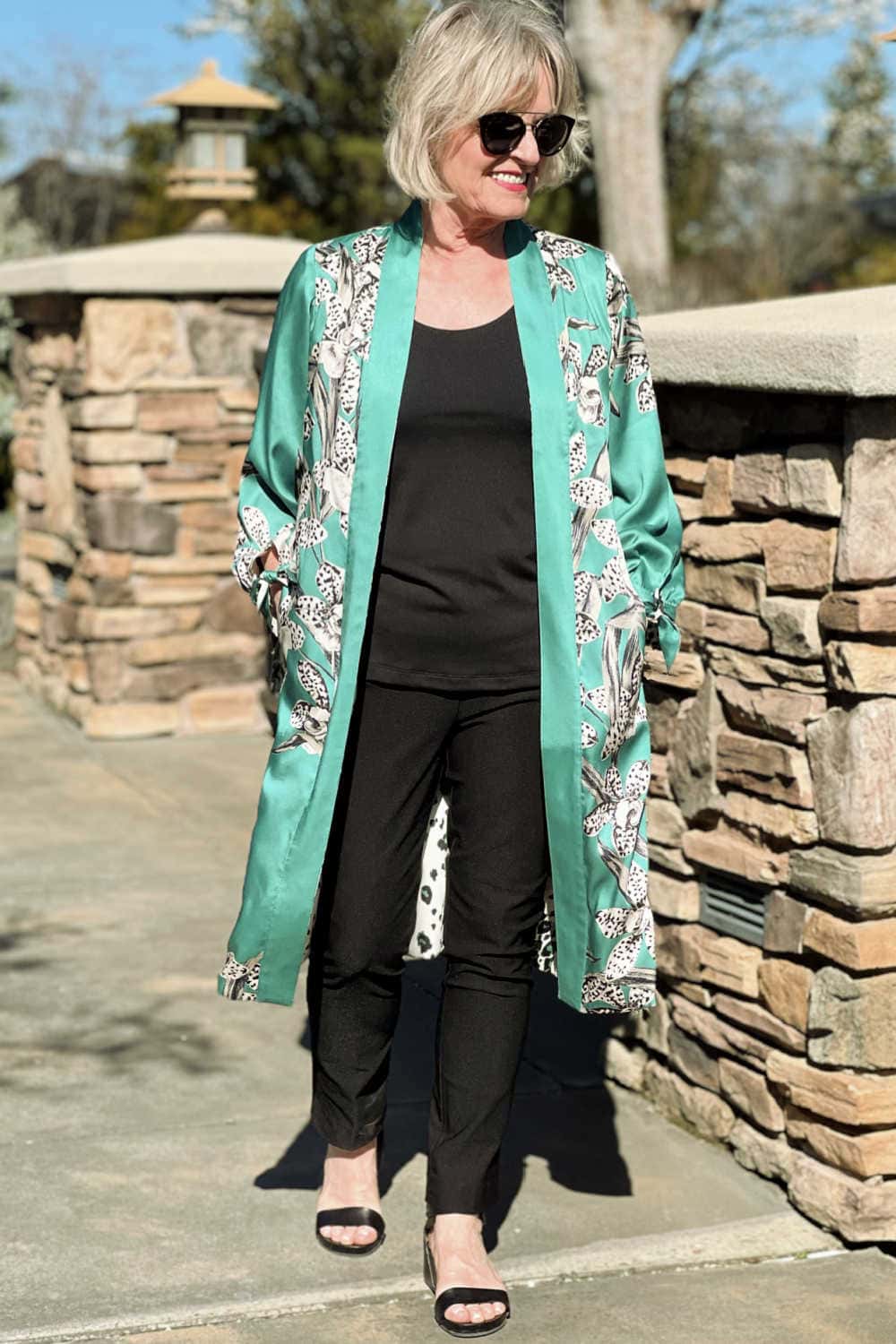 woman wearing fresh green caftan with column of black pants and tank