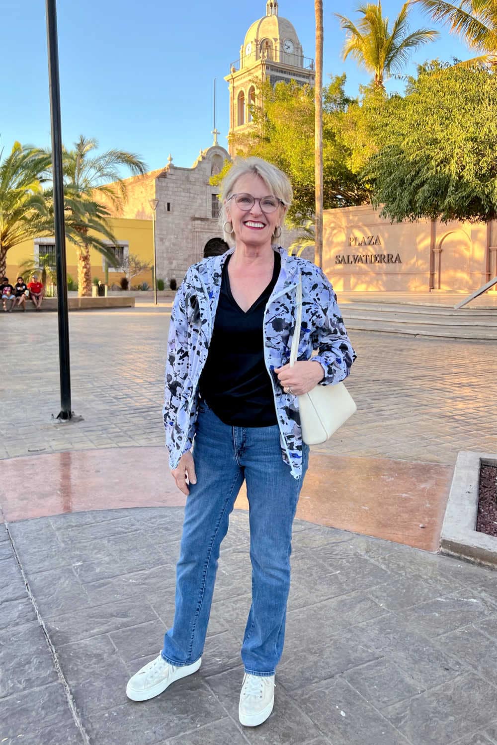 woman wearing windbreaker and jeans