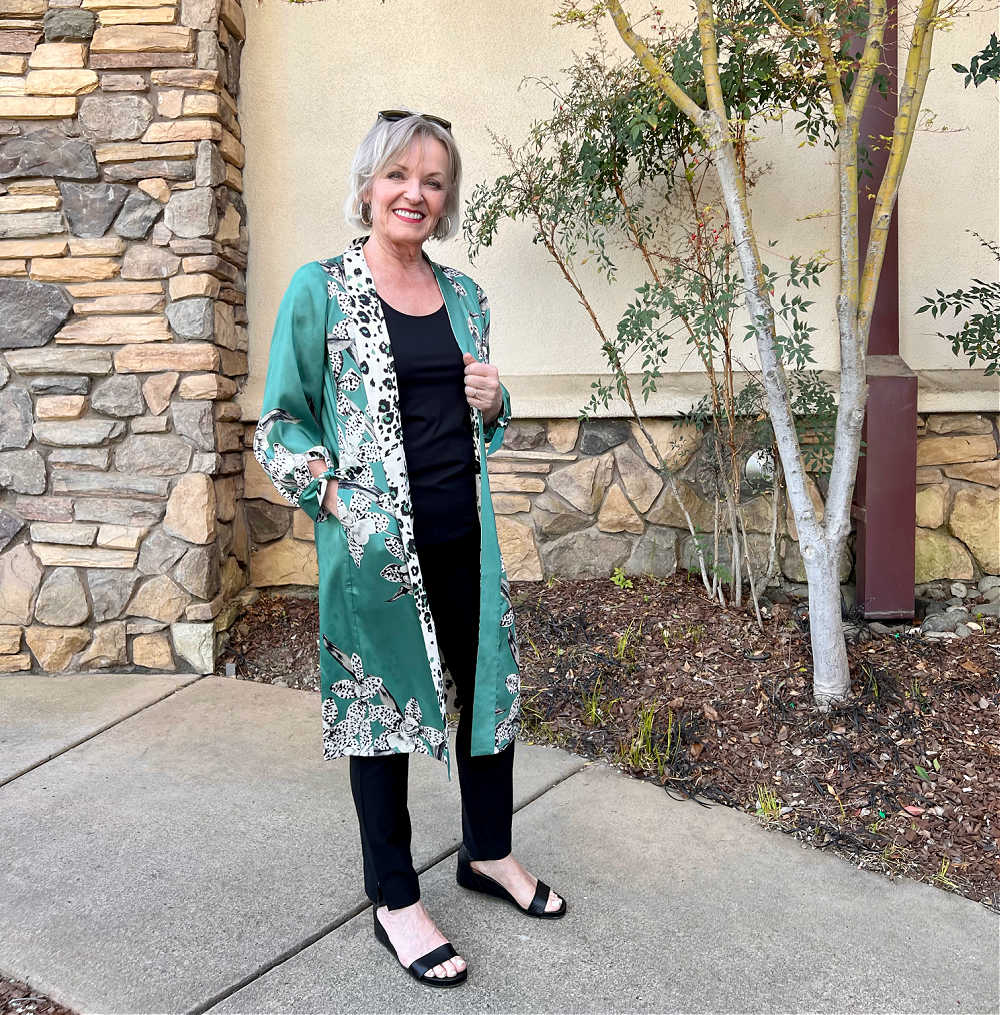 woman wearing kimono over black top and pants