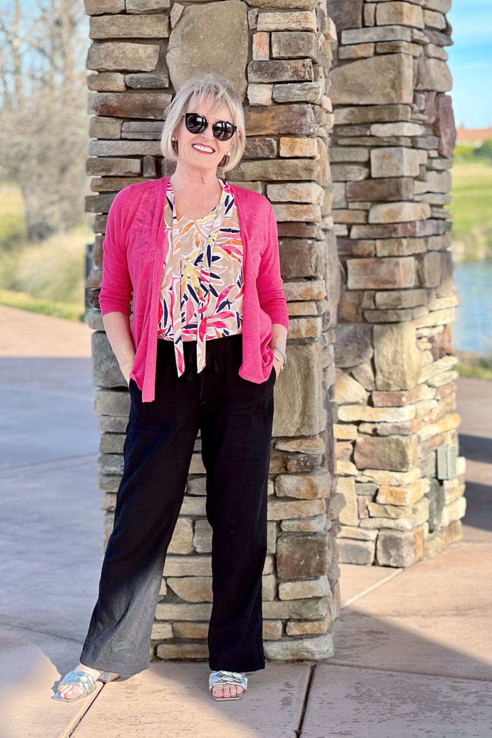 woman wearing pink sweater and black pants