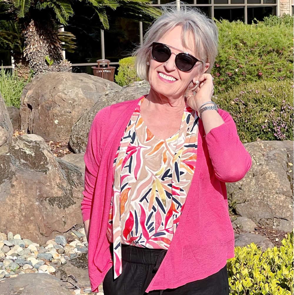 woman in pink cardigan and sunglasses