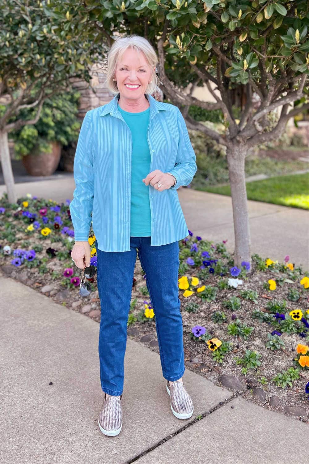 woman in front of flower bed