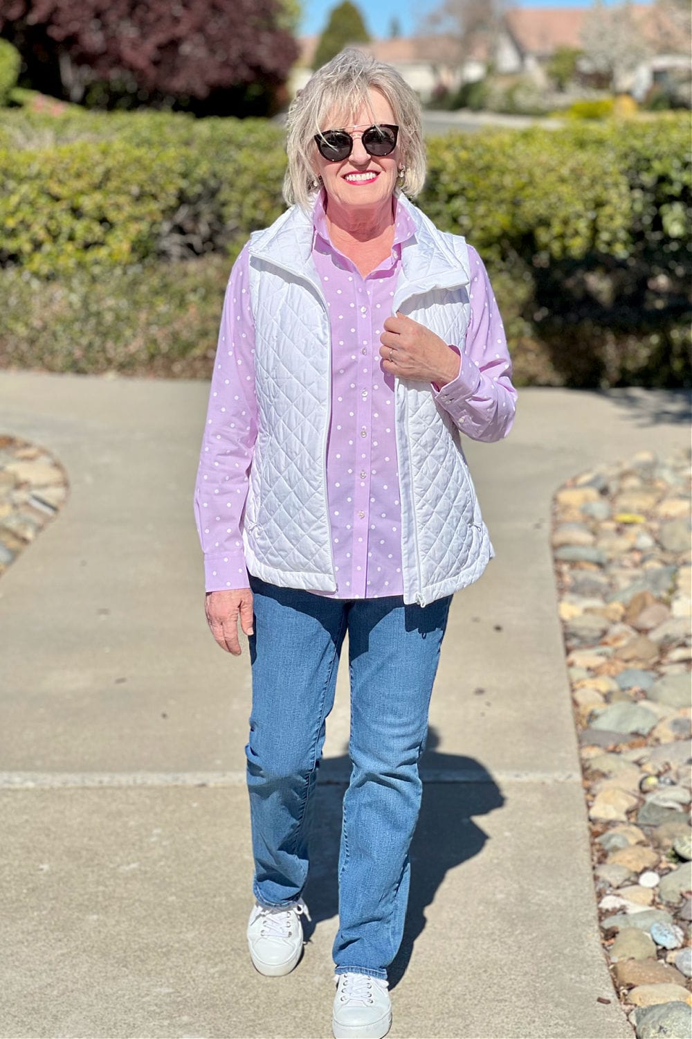 woman walking in vest and jeans