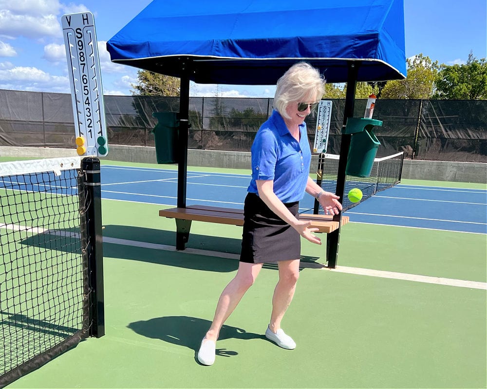 woman wearing chico's skort and linen tee on tennis court