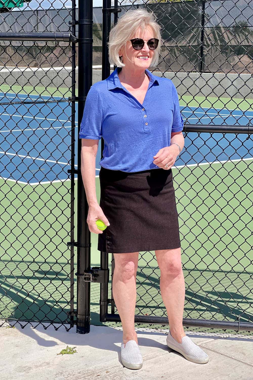 woman in blue shirt and black skort