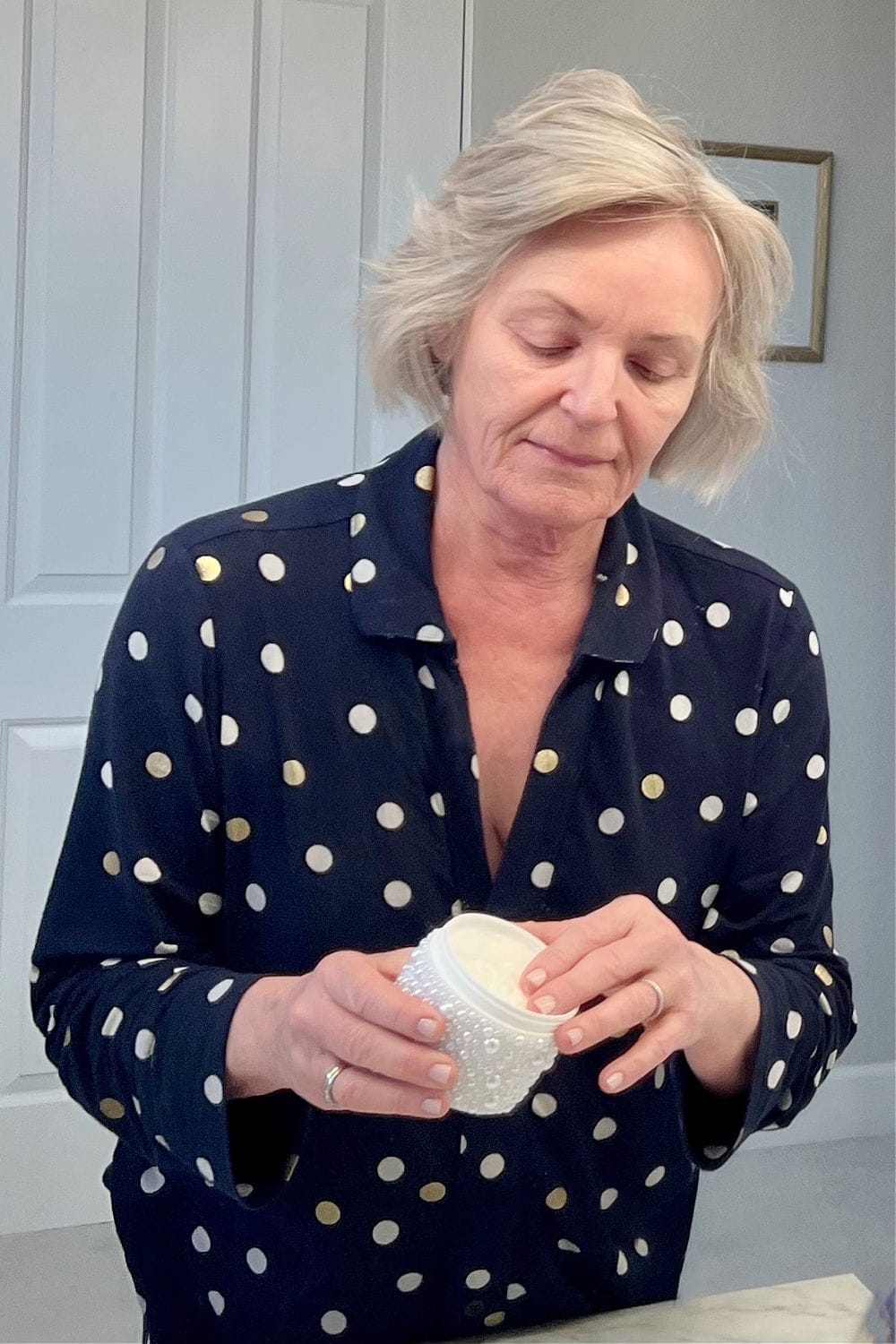woman opening prai cream