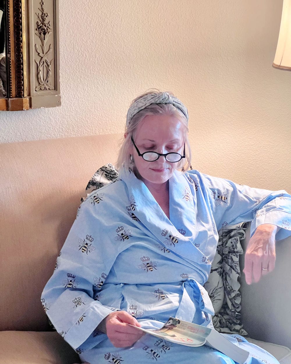 woman reading with honey mask on