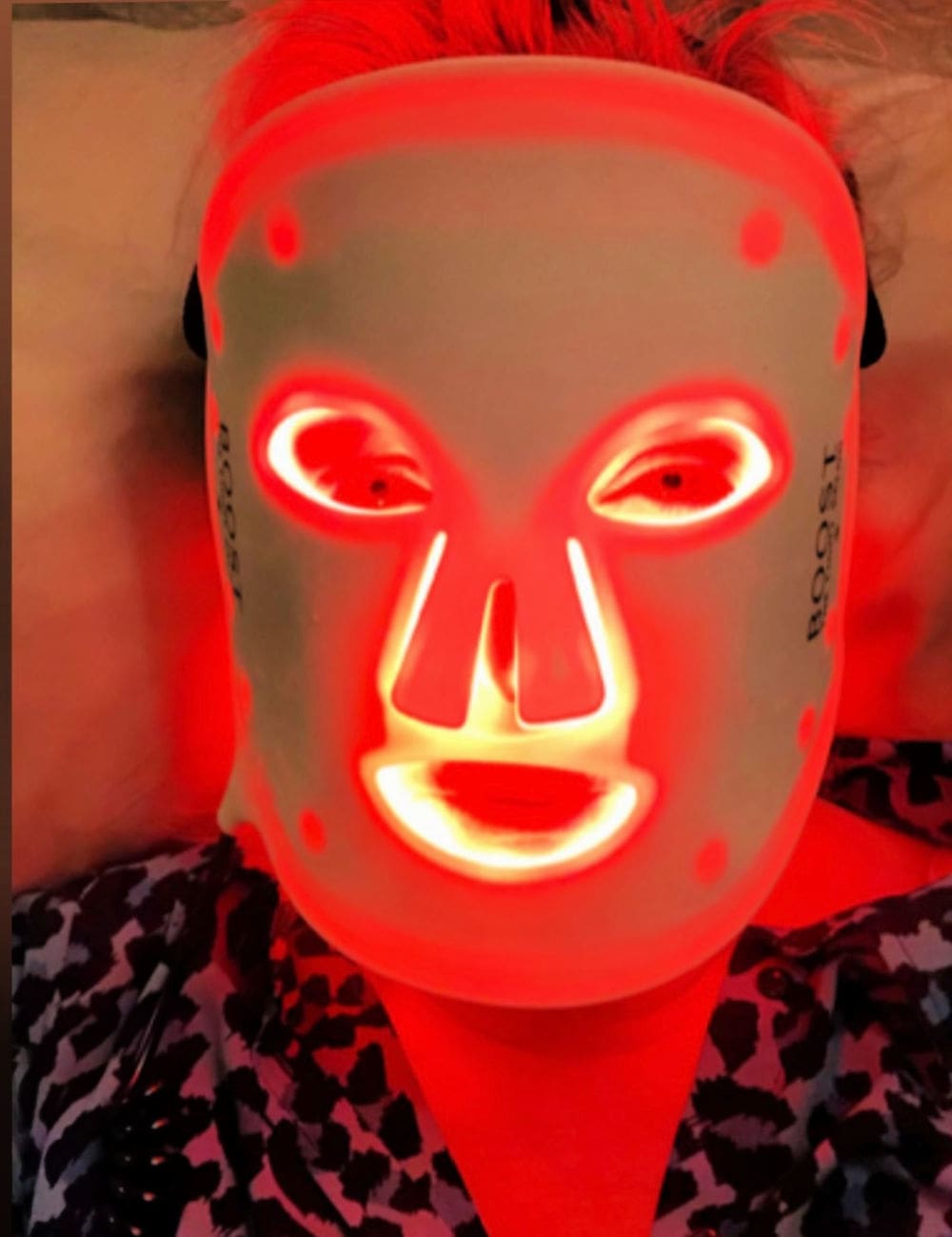 woman using boost red light mask