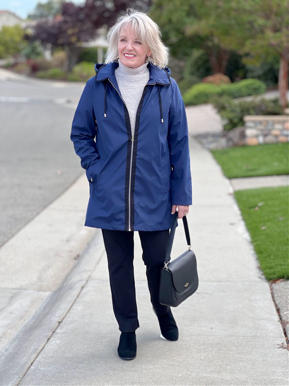 woman walking in nacy jacket and balck pants