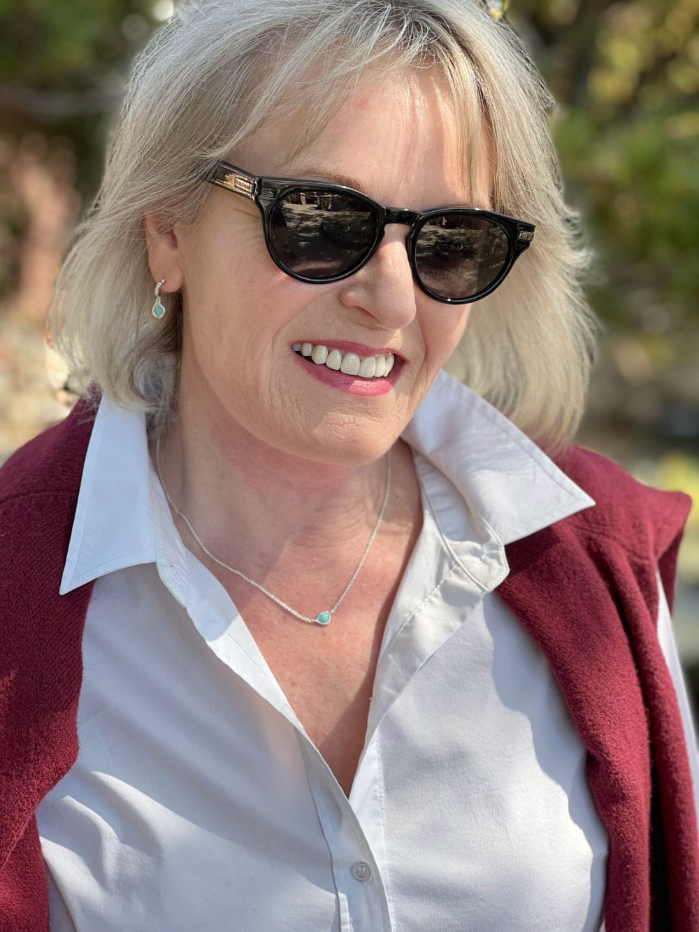 woman wearing monica vinader earrings and necklace