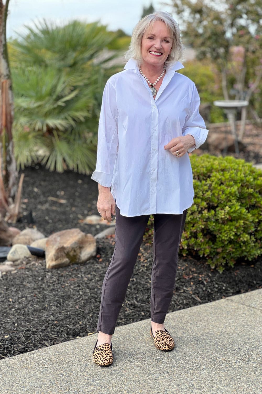 jennifer connolly wearing oversized white poplin shirt and eileen fisher pants with birdies leopard shoes