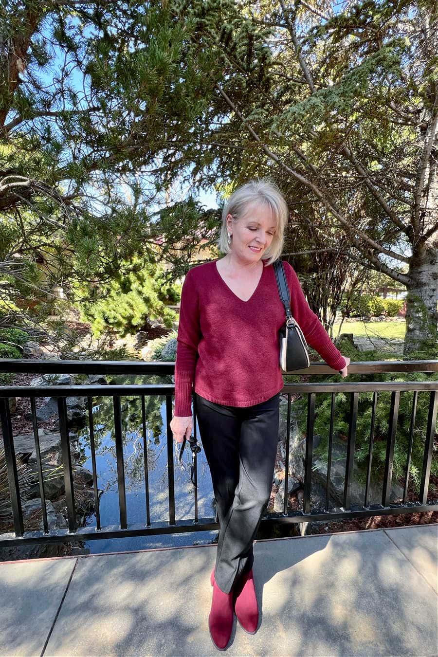 jennifer connoly of a well styled life wearing burgundy v neck and spanx pants