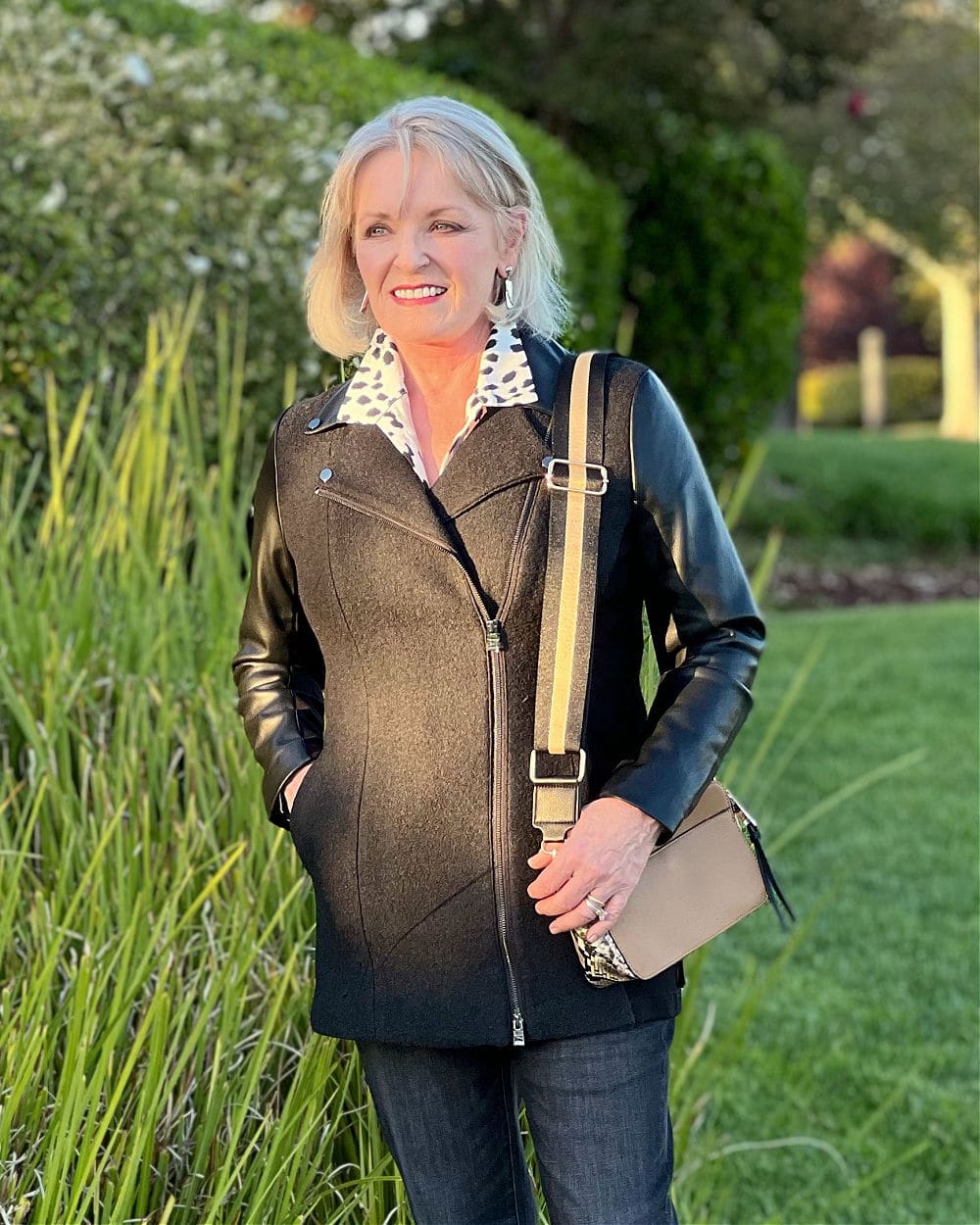 woman wearing neutral outfit of black jacket and black jeans