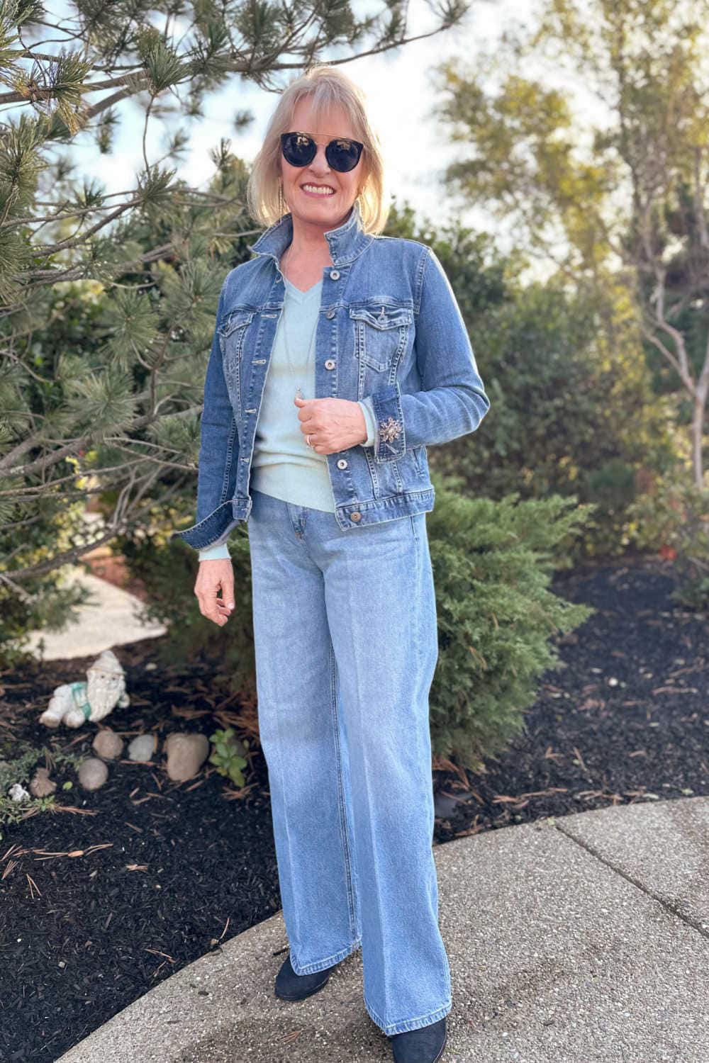 Over 50 fashion blogger wearing wide leg jeans