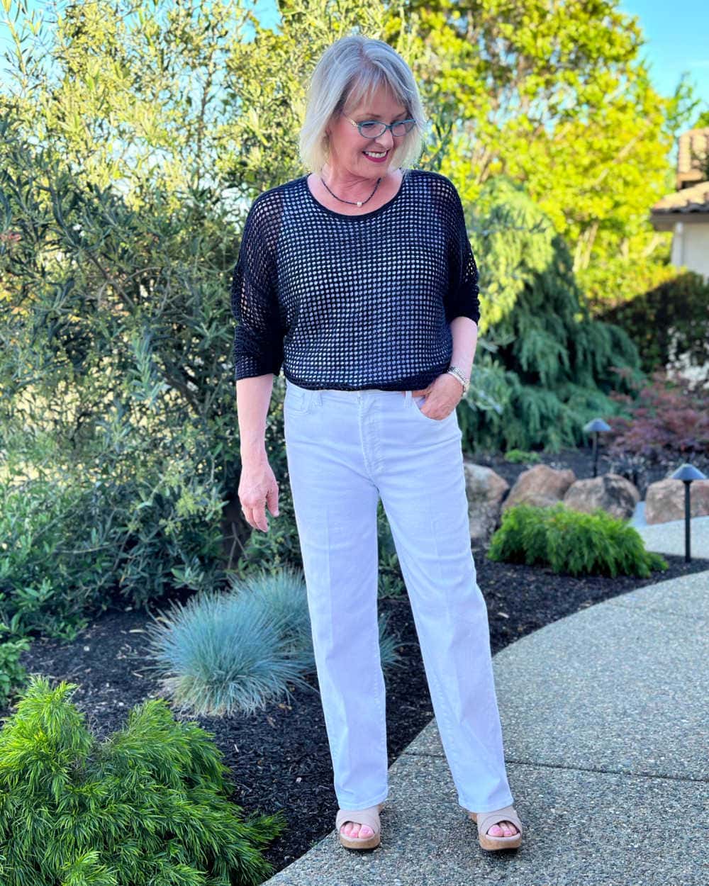 jennifer connolly of a well styled life blog wearing eileen fisher black linen top over white linen tank and white mother jeans