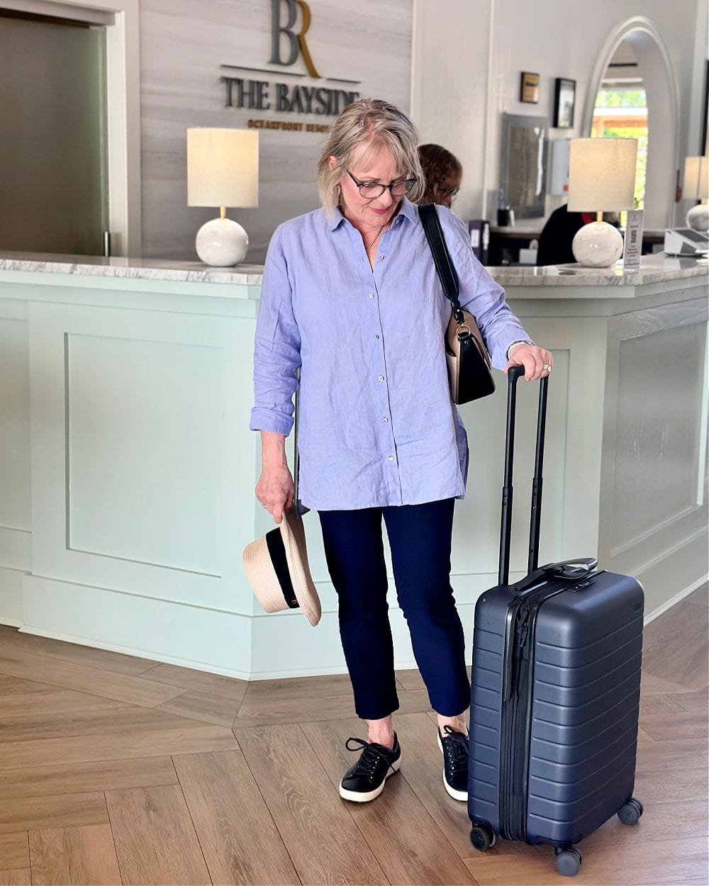 Woman traveling with spring capsule wardrobe