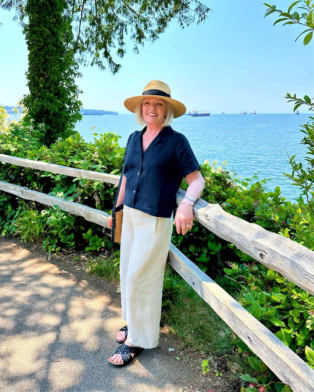 woman wearing black linen pants and top with summer accessories
