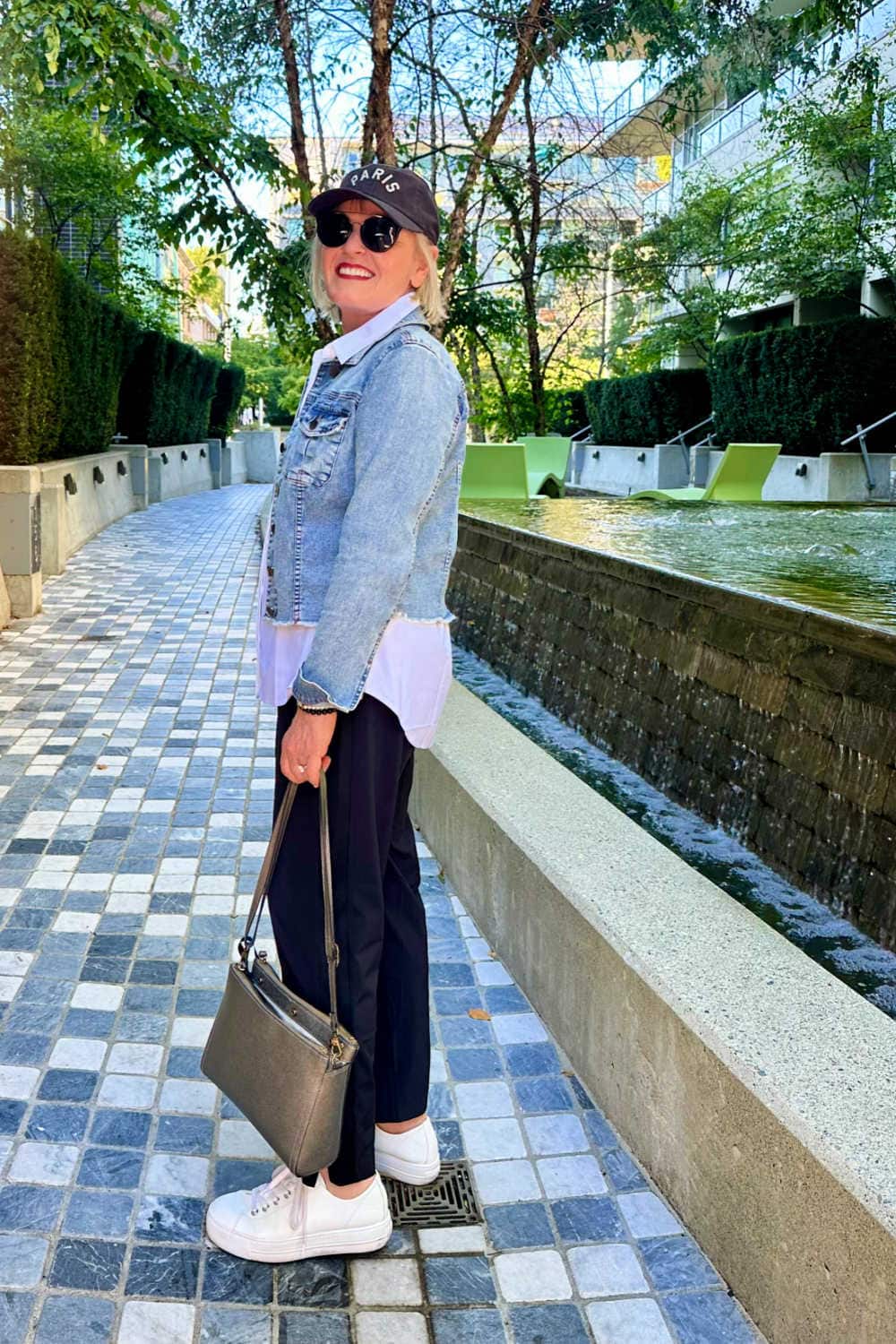 woman wearing denim jacket over white shirt wardrobe essential