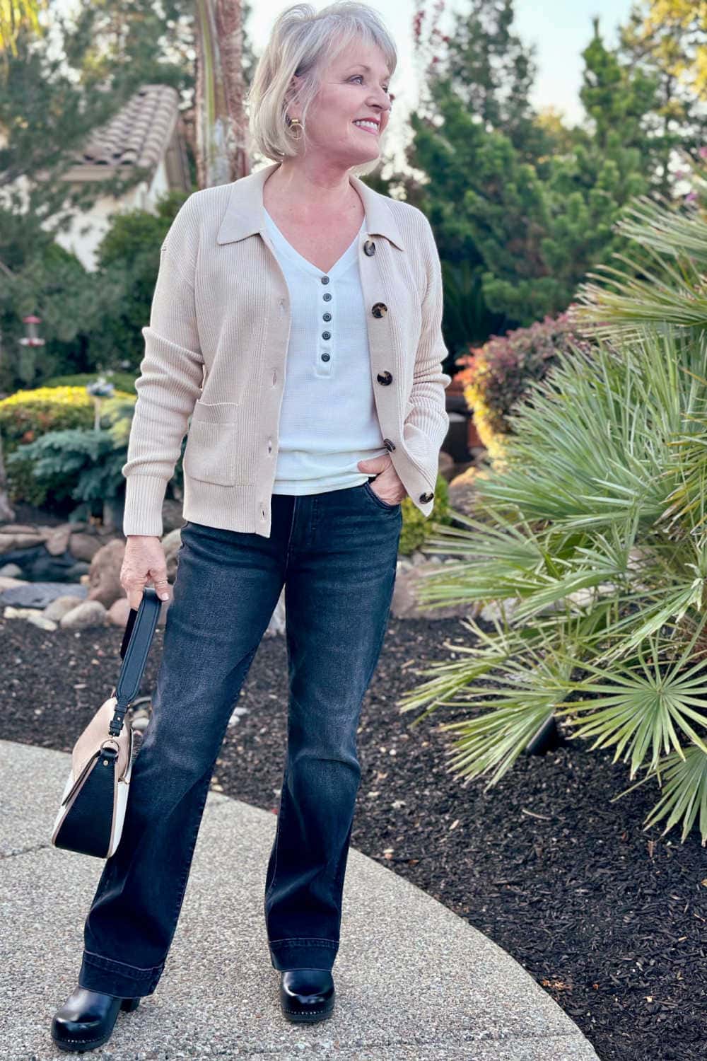 women wearing petite-fiendly beige cardidan and top with black jeans