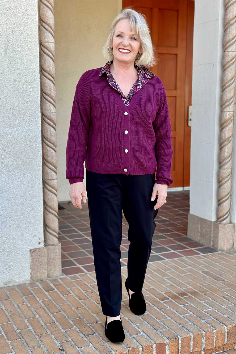 women wearing deep ruby cardigan with black pants and loafers
