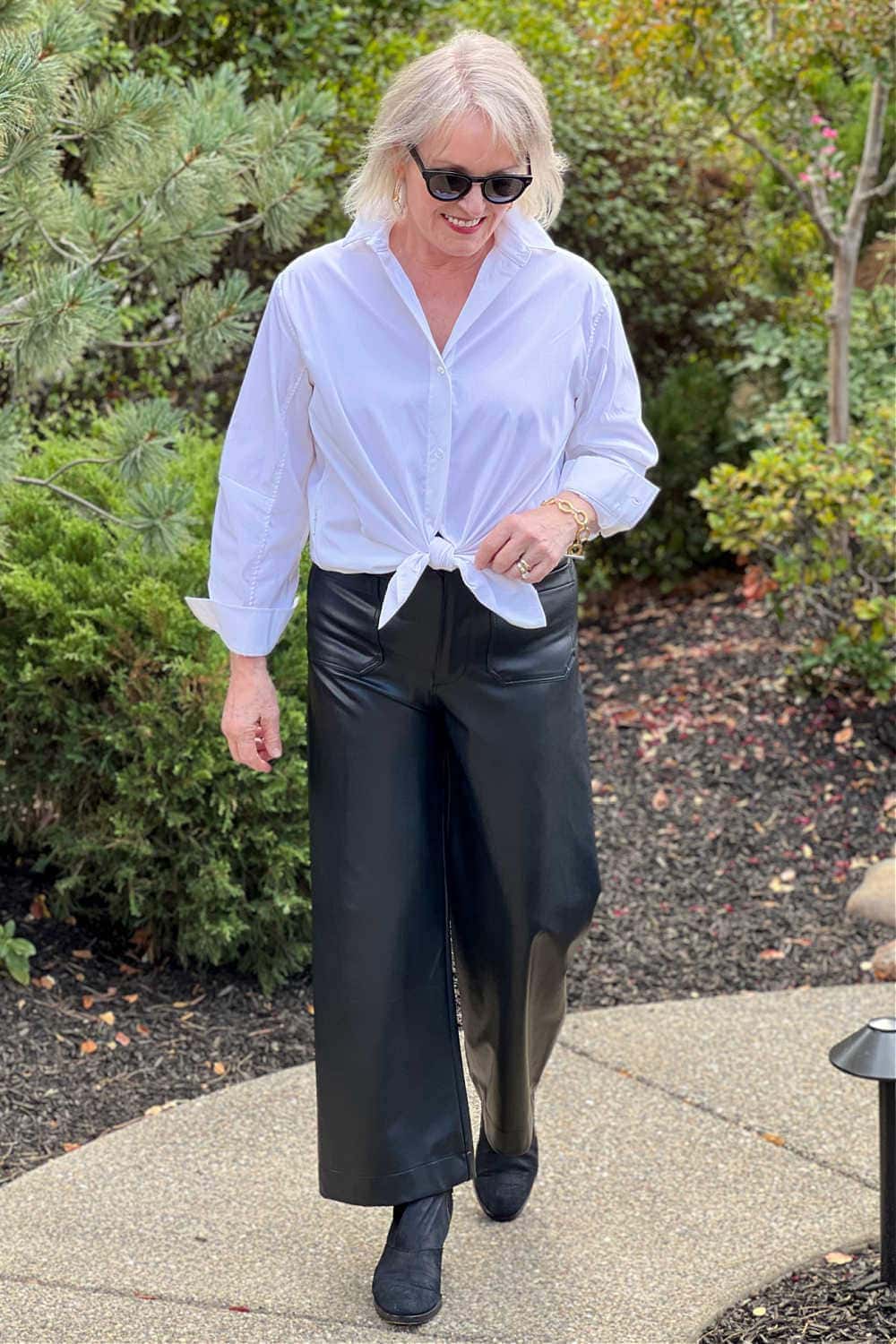 OLDER WOMAN WEARING COLETTE FAUX LEATHER PANTS WITH WHITE SHIRT