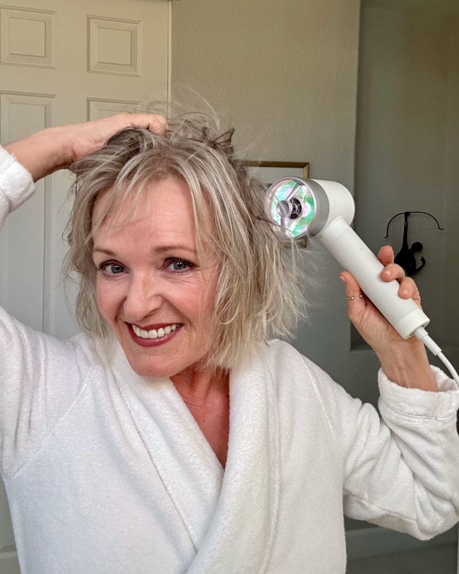 woman drying hair to style for an elegant expensive appearance