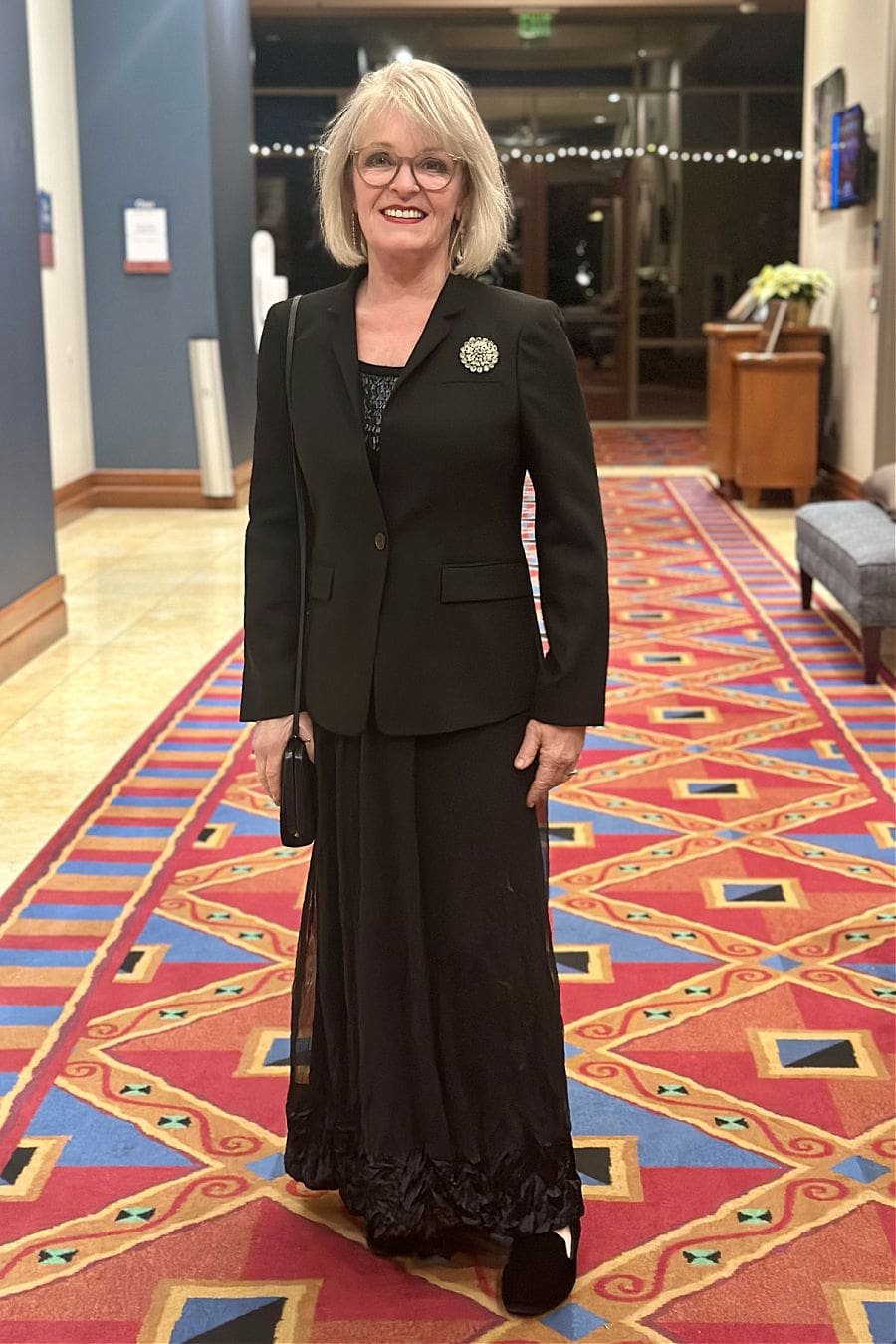 Jennifer Connolly of A Well Styled Life wearing black J. Crew Regent blazer with long skirt and Birdies flats