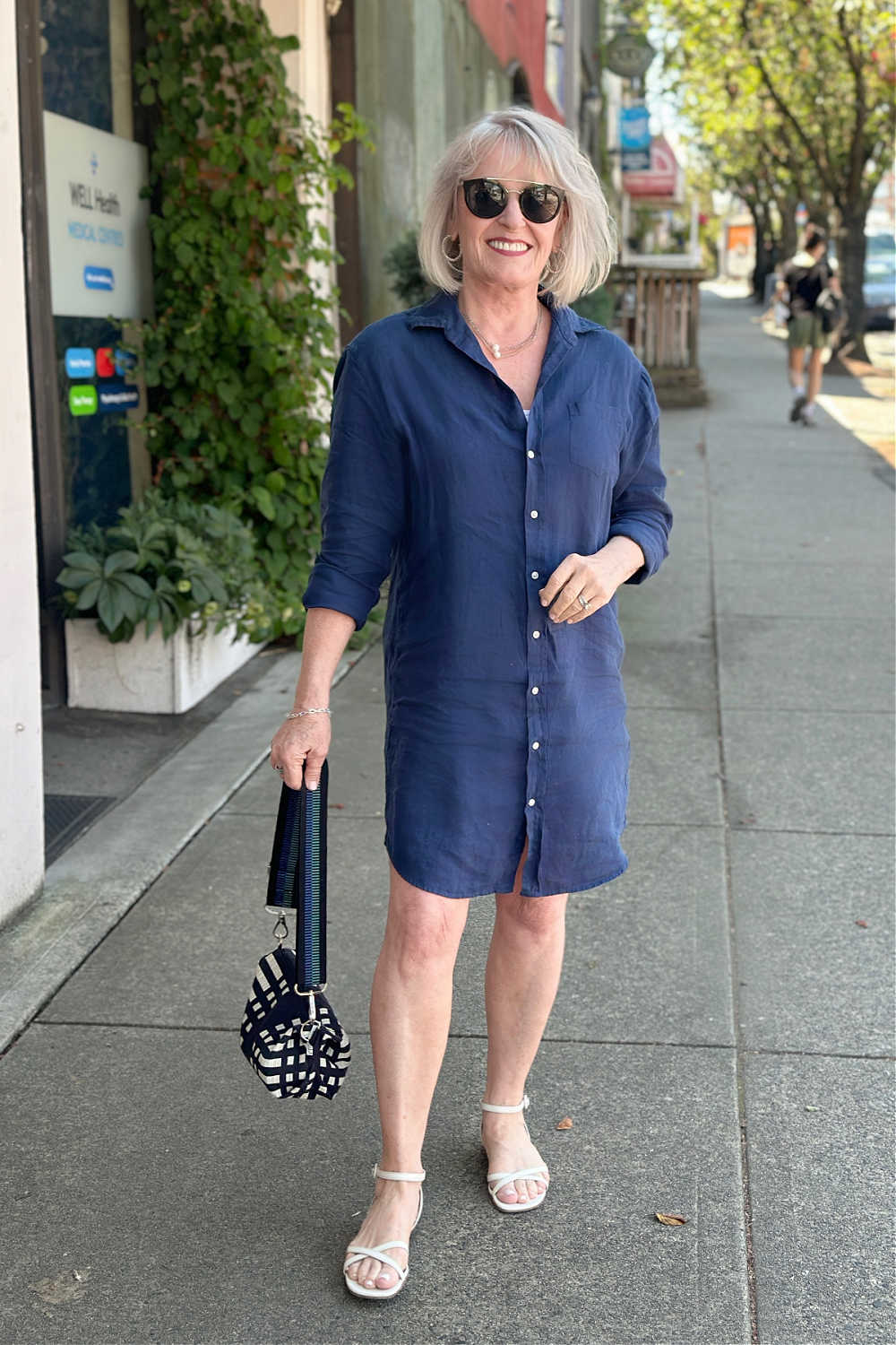 mature women wearing navy linen shirtdress