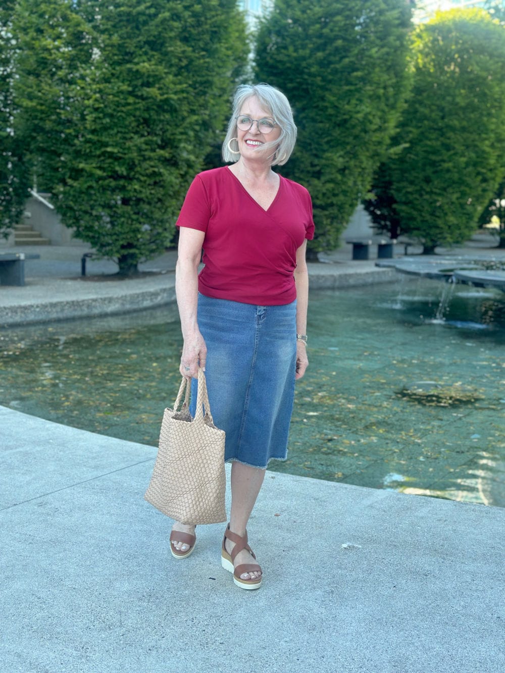 woman wearing red tee and denim skirt
