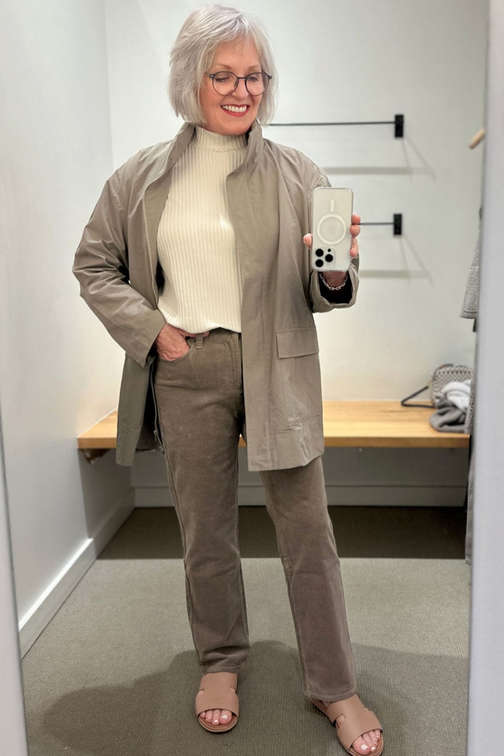 jennifer connolly from a well styled life trying on eileen fisher cotton jacket over corduroy pants in the store