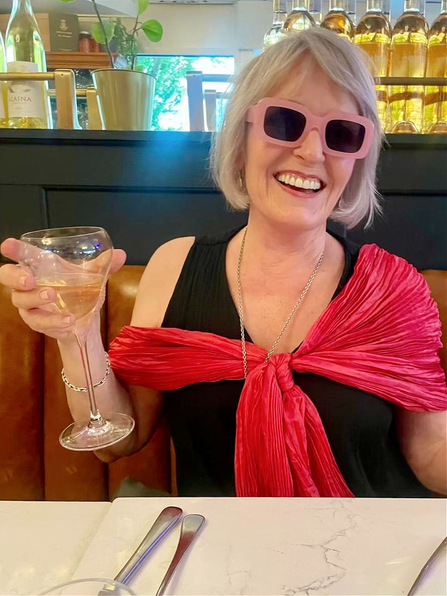 woman wearing pink scarf and black dress