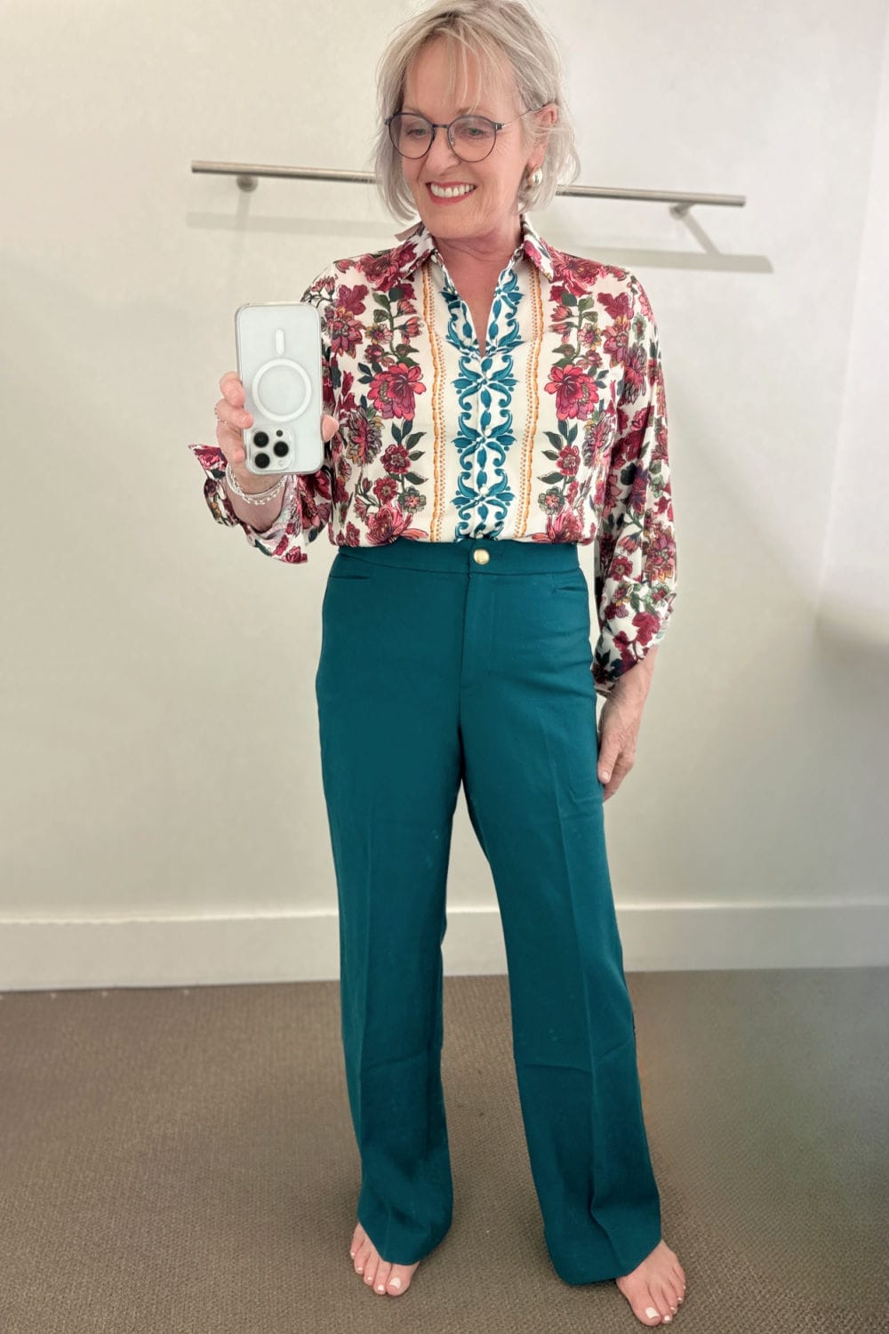 woman wearing teal pants and print blouse in Talbots