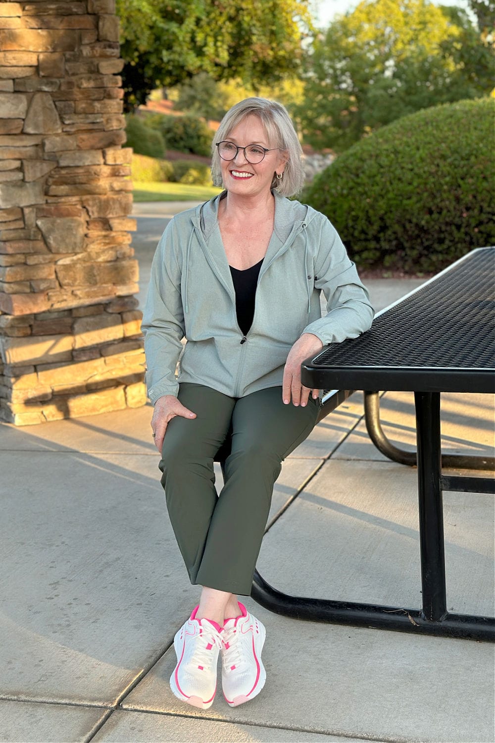 woman sitting on bench wearing Easy Spirit Limited Edition #MoveForPink Maxine sneaker