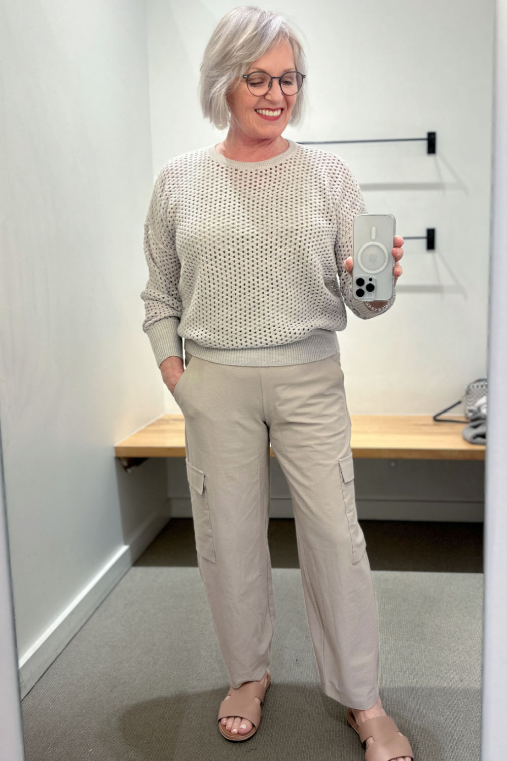 silver haired woman wearing beige pants and sweater