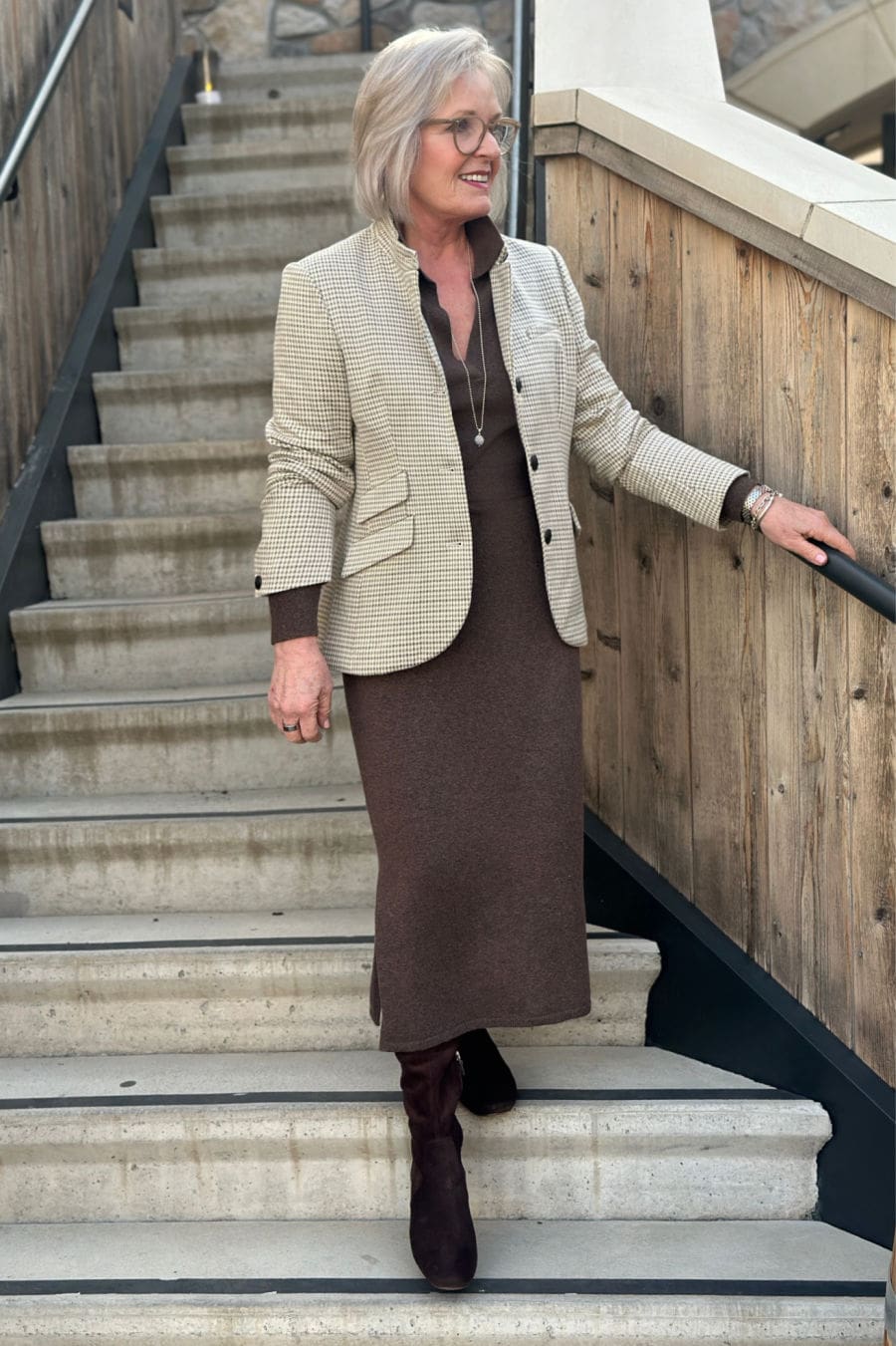 Jennifer Connolly models a neutral sweater dress with suede boots and a blazer