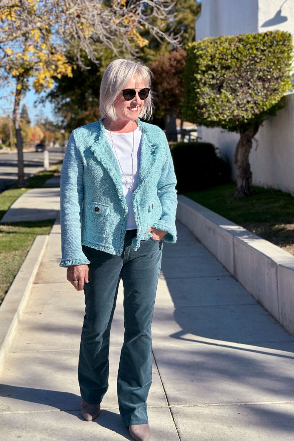jennifer connolly wearing ladies knit blazer with corduroy pants in aqua and teal color