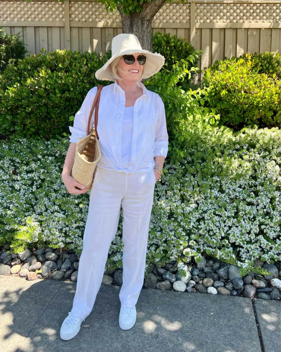 WOMAN WEARING NATURAL COLORED CANVAS SUN HAT TO PROTECT FACE FROM SUN