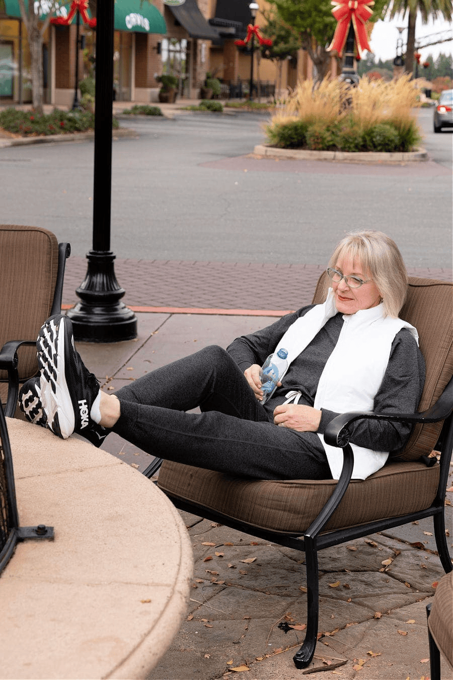 over 60 woman wearing work out clothes and Hoka Clifton 9 wide supportive sneakers for walking and travel