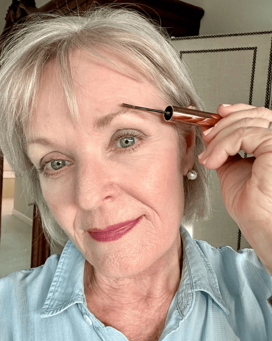 Women over 50 applying brow gel to quickly look more polished and put together