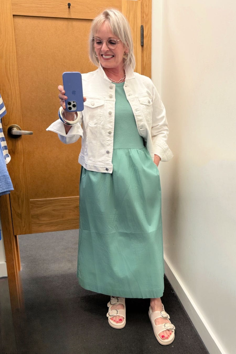 Woman over 60 wearing eucalyptus green ribbed knit dress and white denim jacket from J.Crew Factory summer collection