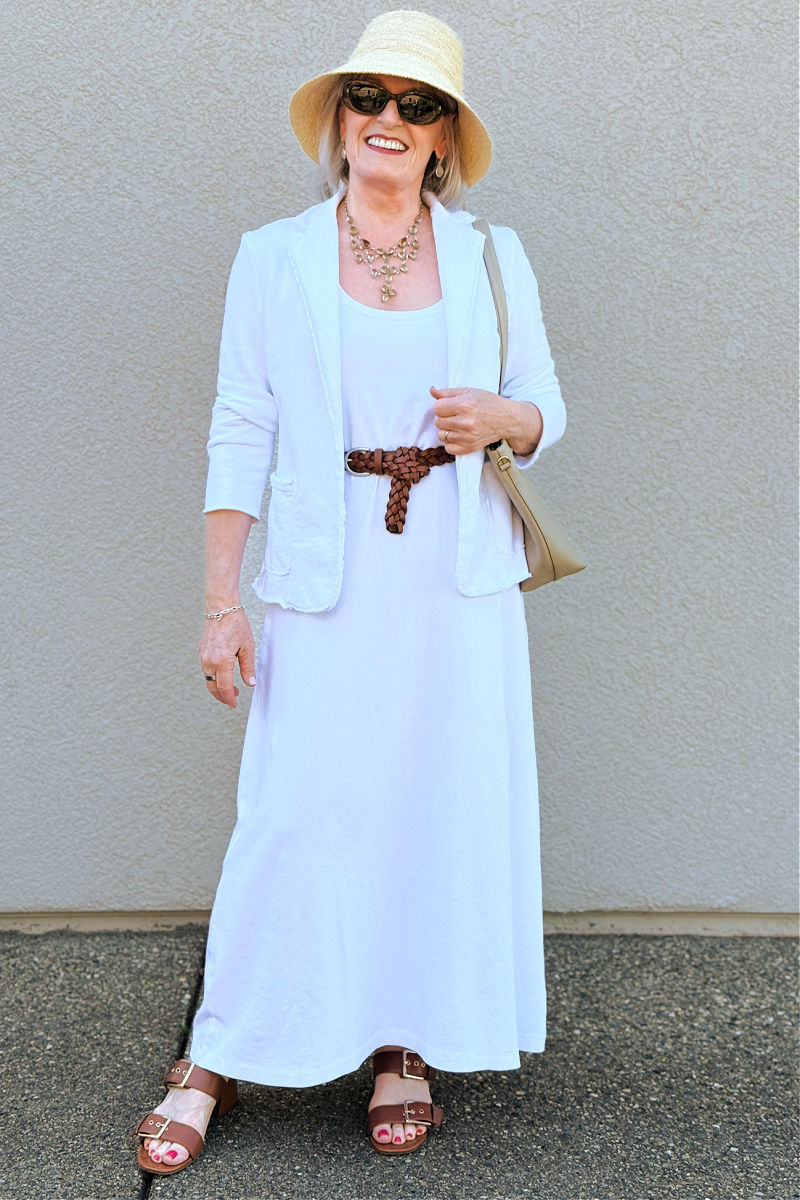 White dress styled with brown accessories, fleece blazer, and statement necklace for a fall outfit over 60