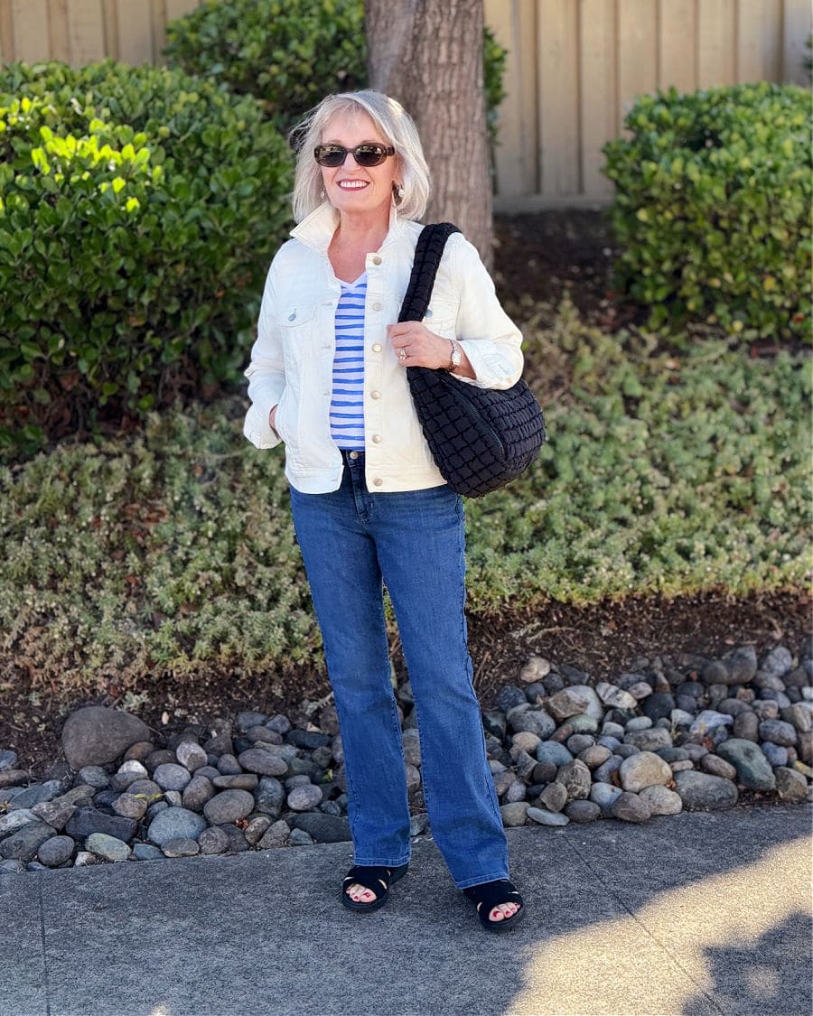 Levi’s bootcut jeans styled for women over 50 with sandals and a striped tee